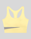 TrackLine Synergy Racerback Sports Bra in Light Yellow with Light Gray color-block detail, front view