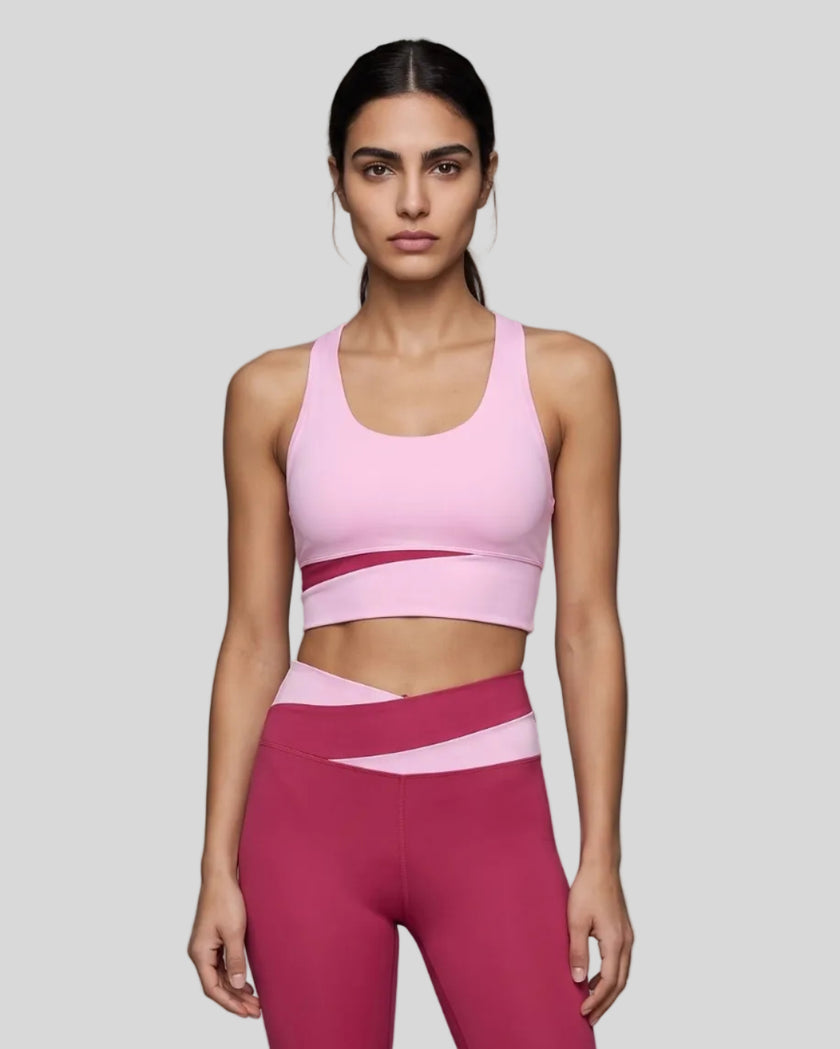 Woman wearing TrackLine Synergy Racerback Sports Bra in Rose Red with Pink detail, front view