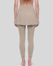 Woman wearing TrackLine Synergy Skirted Leggings in Light Coffee with integrated flared skirt, lower body back view