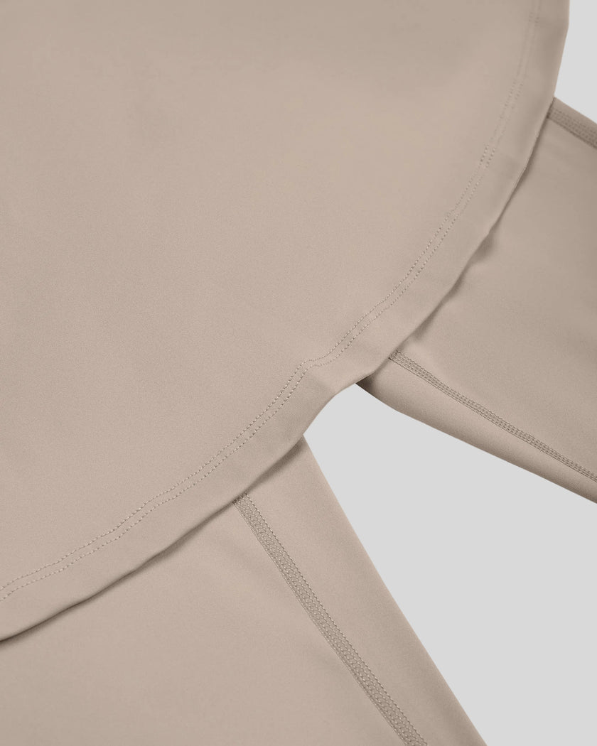 Close-up of flared skirt hem on TrackLine Synergy Skirted Leggings in Light Coffee