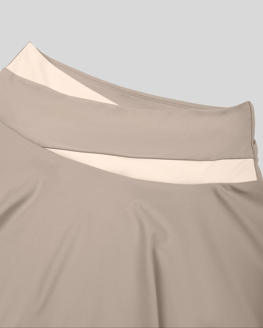 Close-up of high-rise crossover waistband on TrackLine Synergy Skirted Leggings in Light Coffee and Apricot