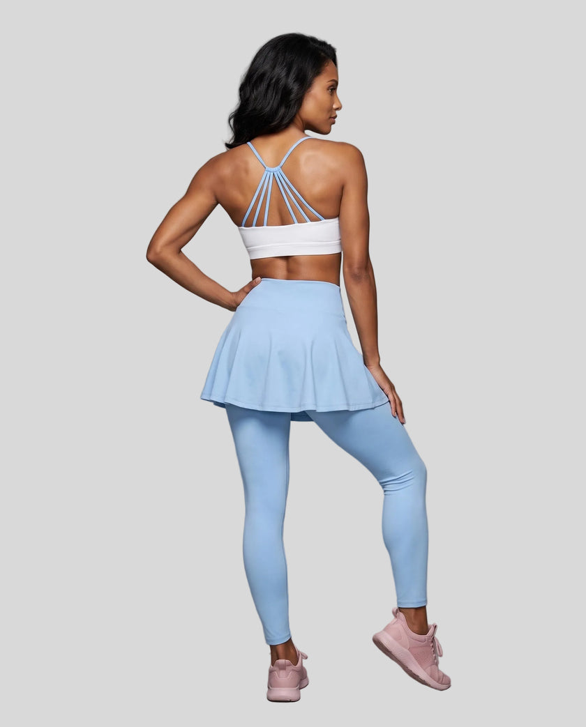 Woman wearing TrackLine Synergy Skirted Leggings in Sky Blue with integrated flared skirt, back view
