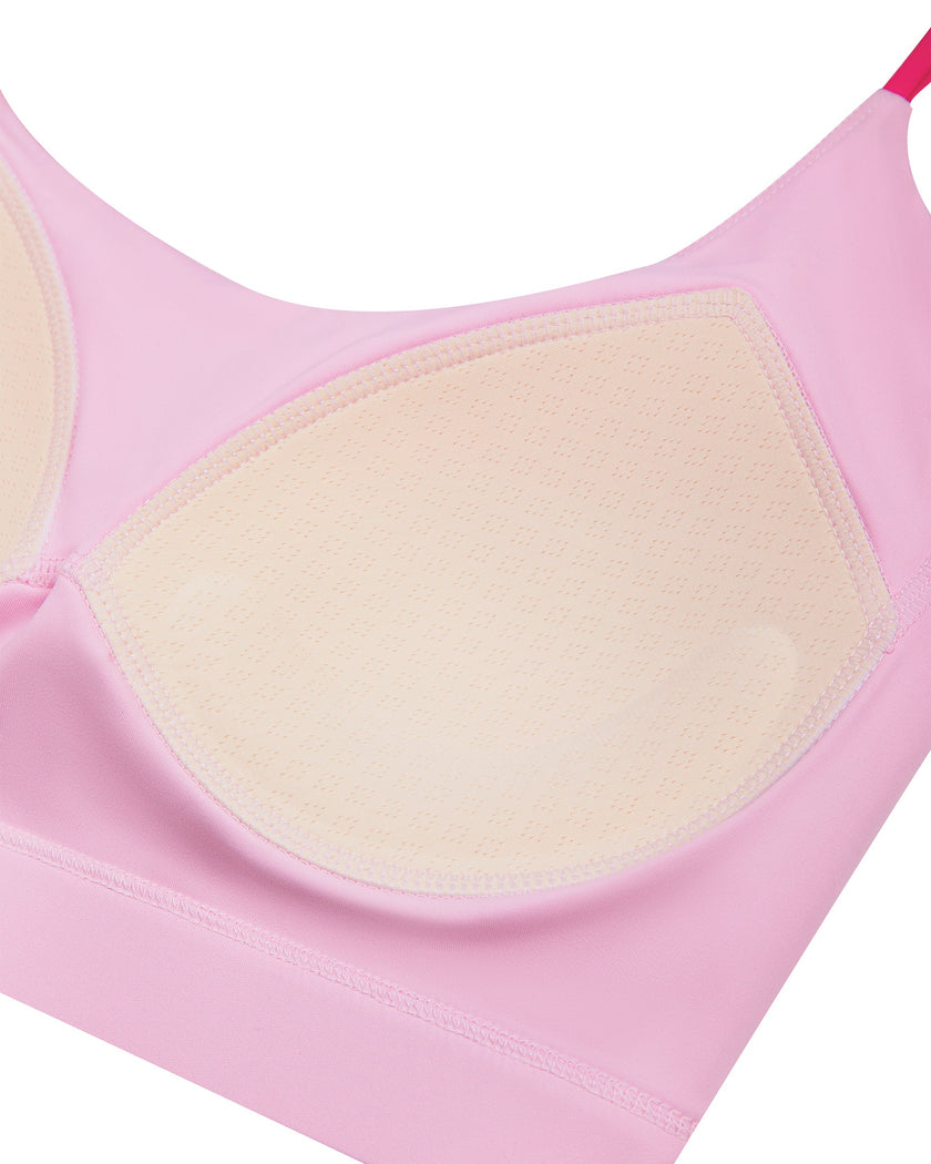TrackLine Synergy Strappy Sports Bra in Pink with Rose Red, close-up showing built-in chest pads