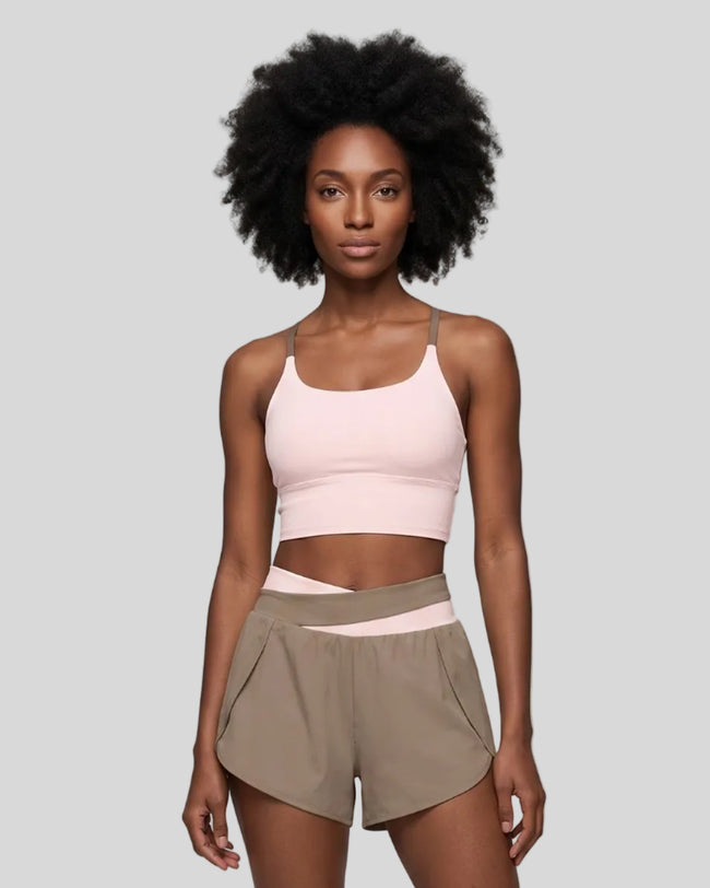 Woman wearing TrackLine Synergy Tank Top in Apricot with Khaki straps, front view