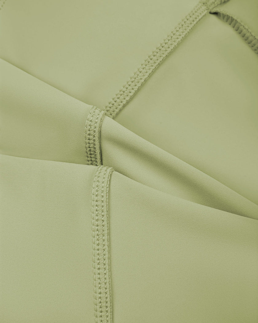 Close-up of smooth stretch fabric on TrackLine Synergy Tank Top in Bean Green