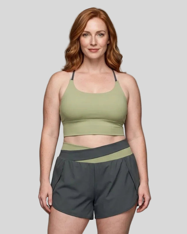 Woman wearing TrackLine Synergy Tank Top in Bean Green with Dark Gray straps, front view