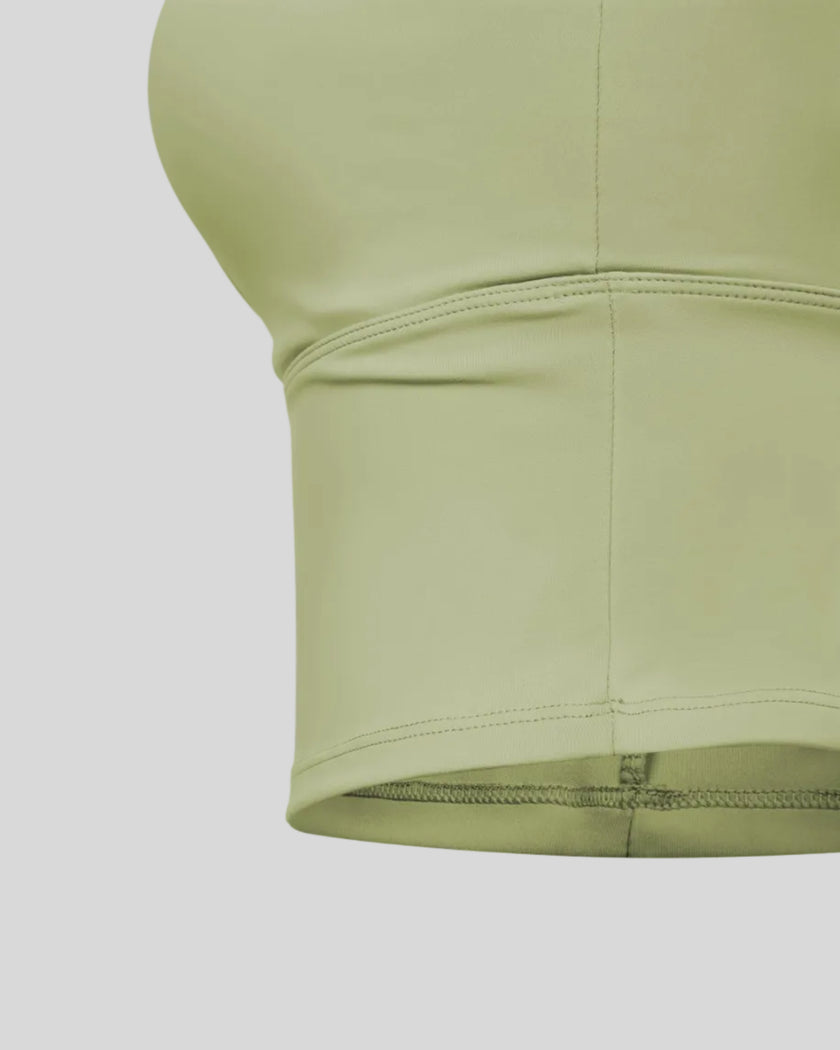 Close-up of extended underbust construction on TrackLine Synergy Tank Top in Bean Green