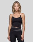 Woman wearing TrackLine Synergy Tank Top in Black with White straps, front view