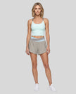 Woman modeling a Light Blue with Light Gray TrackLine Synergy Tank Top and matching shorts, paired with white sneakers.