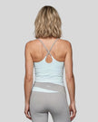 Woman wearing TrackLine Synergy Tank Top in Light Blue with Light Gray crossover straps, back view