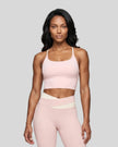 Woman wearing TrackLine Synergy Tank Top in Light Pink with Apricot straps, front view
