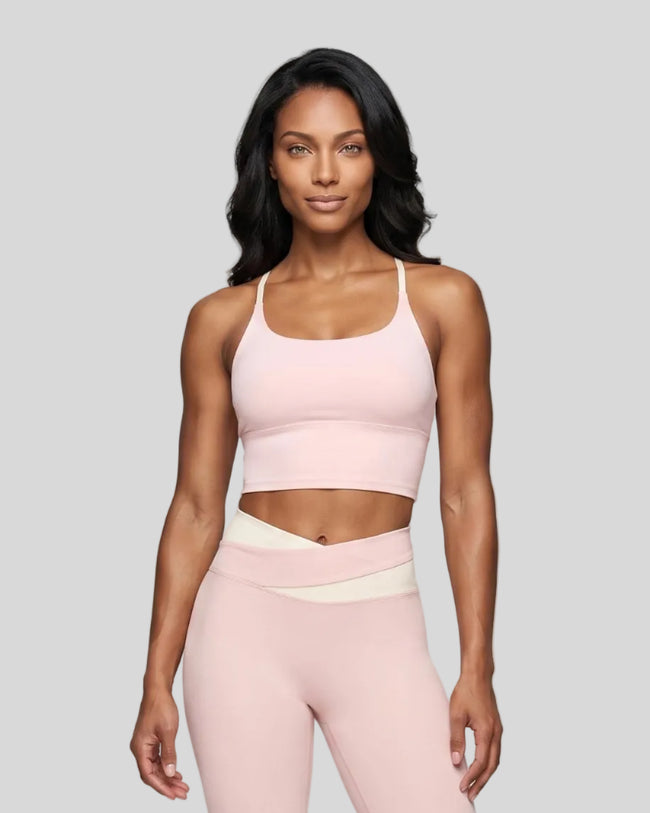 Woman wearing TrackLine Synergy Tank Top in Light Pink with Apricot straps, front view