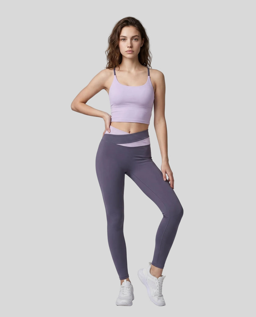 Woman modeling a Light Purple with Deep Purple TrackLine Synergy Tank Top and matching leggings, paired with white sneakers.