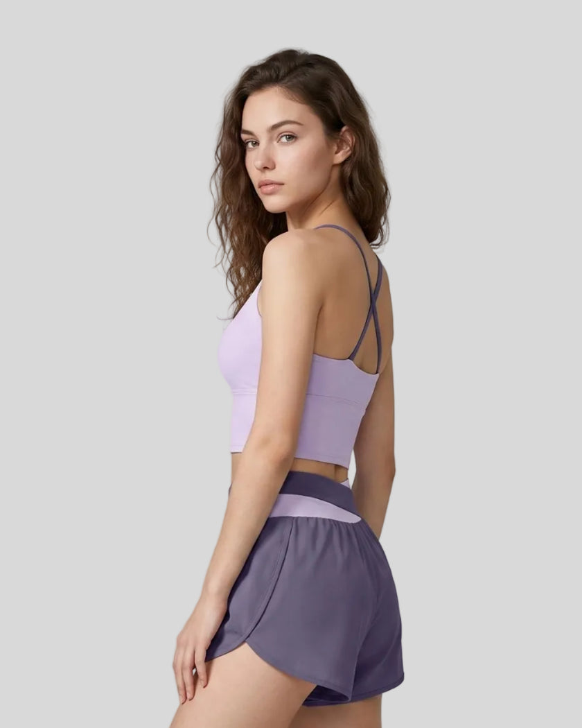 Woman wearing TrackLine Synergy Tank Top in Light Purple with Deep Purple straps, angled back view
