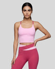 Woman wearing TrackLine Synergy Tank Top in Pink with Rose Red straps, front view