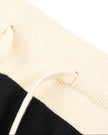 Closeup of the contrast waistband and drawstring detail on the Athlesi TrackLine Track Shorts in black