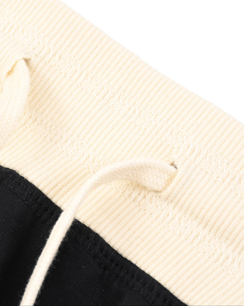 Closeup of the contrast waistband and drawstring detail on the Athlesi TrackLine Track Shorts in black