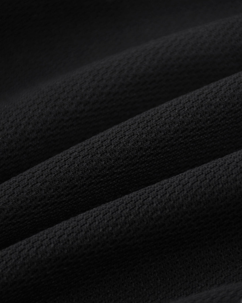 Closeup of the lightweight cotton blend fabric texture on the Athlesi TrackLine Track Shorts in black