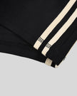 Hem and side stripe detail closeup of the Athlesi TrackLine Track Shorts in black