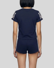 Mid body back view of the Athlesi TrackLine Track Shorts in blue paired with the TrackLine Varsity Tee