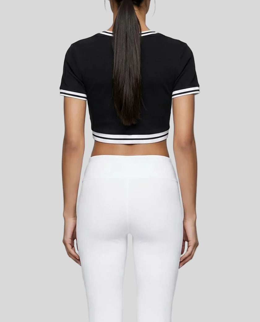 Mid body back view of the Athlesi TrackLine V-Neck Crop Tee in black