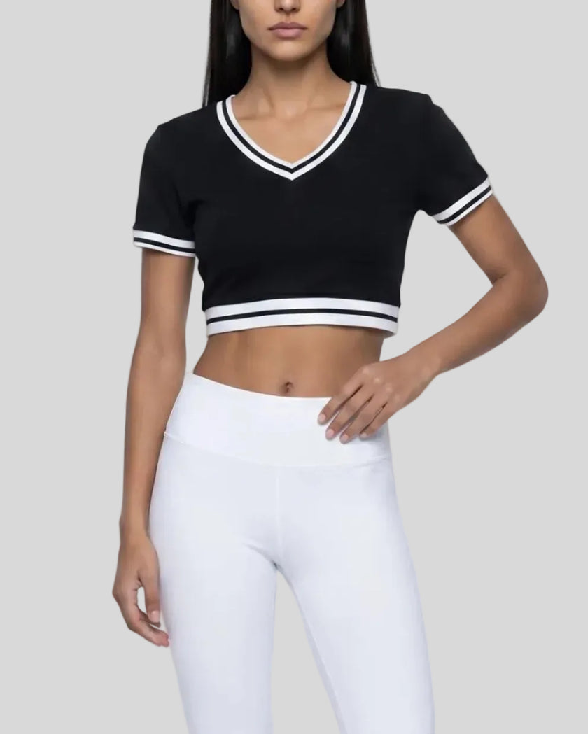 Angled front view of the Athlesi TrackLine V-Neck Crop Tee in black with retro-inspired stripe detailing