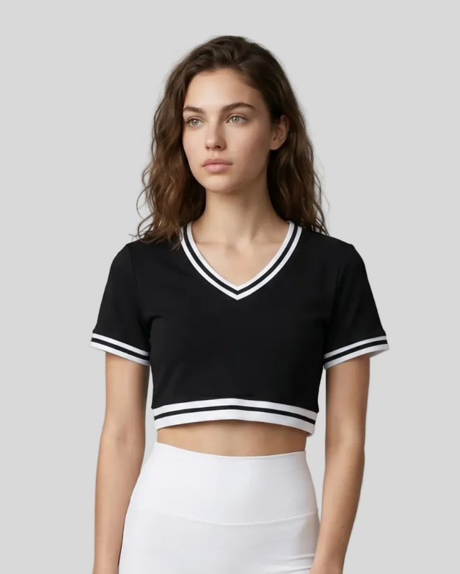 Upper body front view of a woman wearing the Athlesi TrackLine V-Neck Crop Tee in black