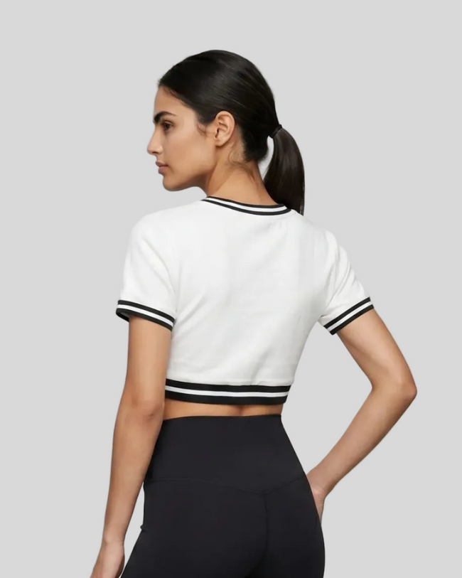Upper body back view of the Athlesi TrackLine V-Neck Crop Tee in white