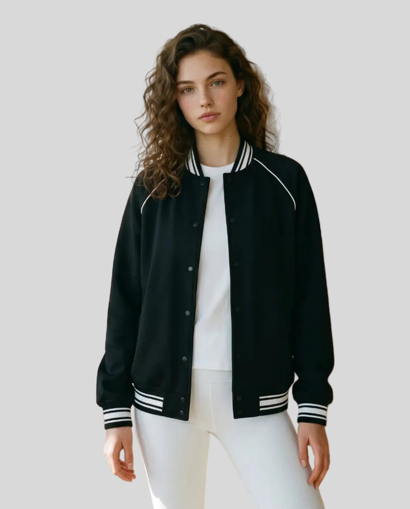 Model wearing the TrackLine Varsity Jacket in Black partially open front view