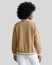 Back view of a model wearing the TrackLine Varsity Jacket in Khaki