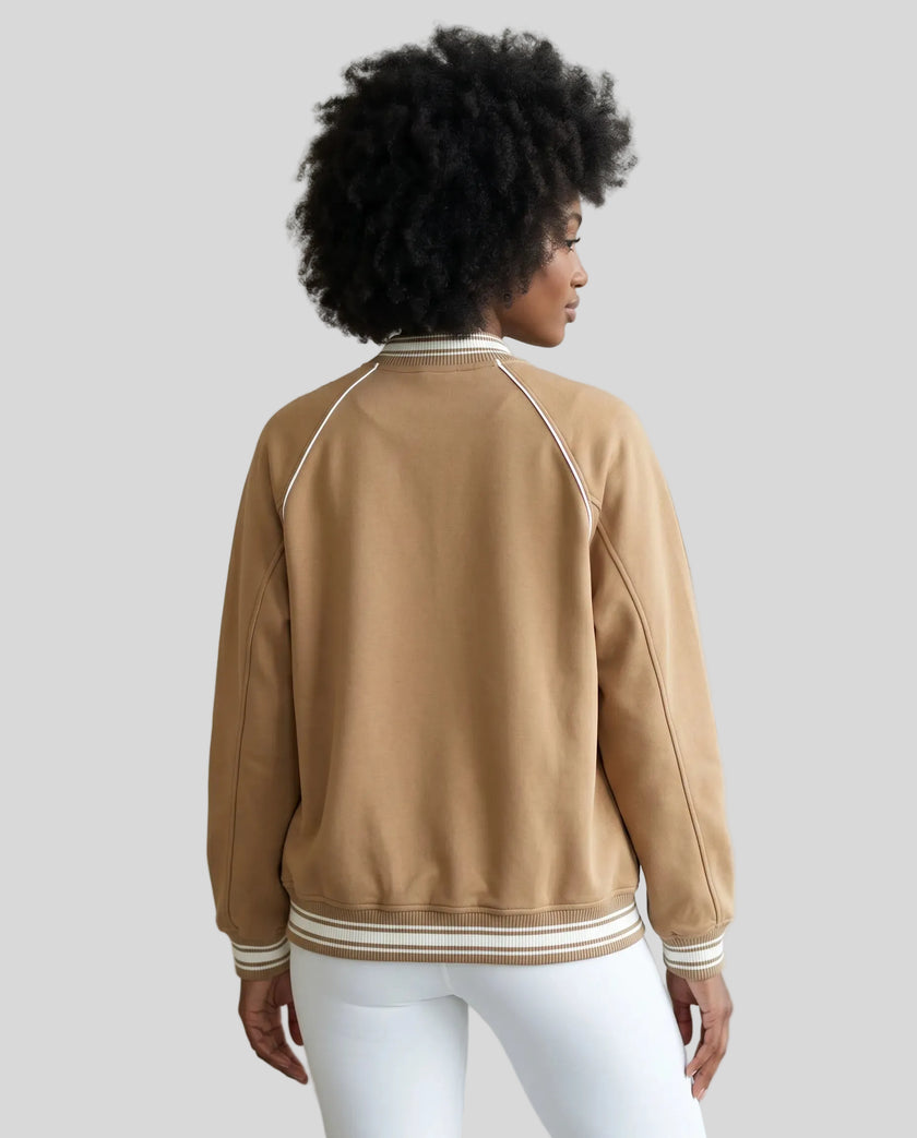 Back view of a model wearing the TrackLine Varsity Jacket in Khaki