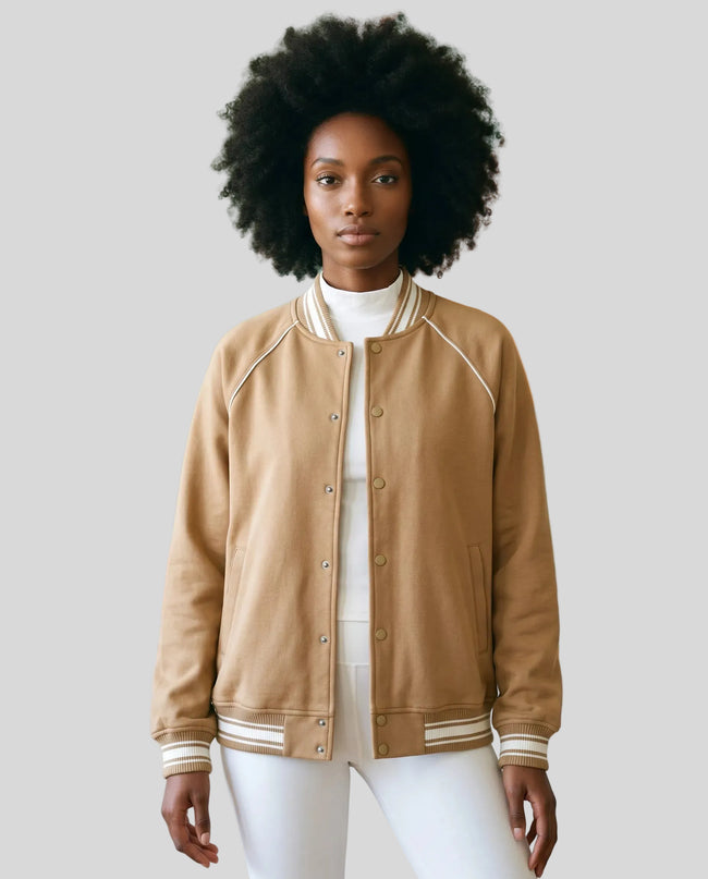Model wearing the TrackLine Varsity Jacket in Khaki partially open front view