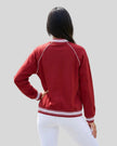 Back view of a model wearing the TrackLine Varsity Jacket in Red