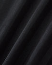 Closeup of the textured vertical stripe fabric on the Athlesi TrackLine Varsity Jersey in black and white