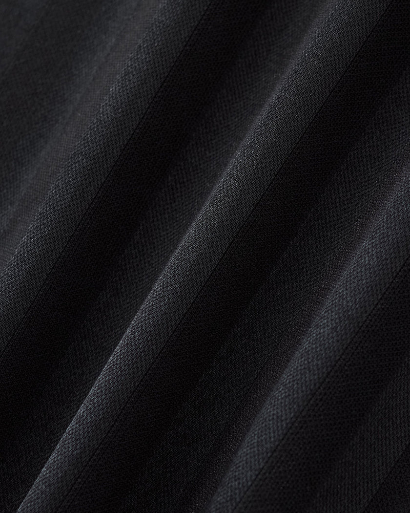 Closeup of the textured vertical stripe fabric on the Athlesi TrackLine Varsity Jersey in black and white