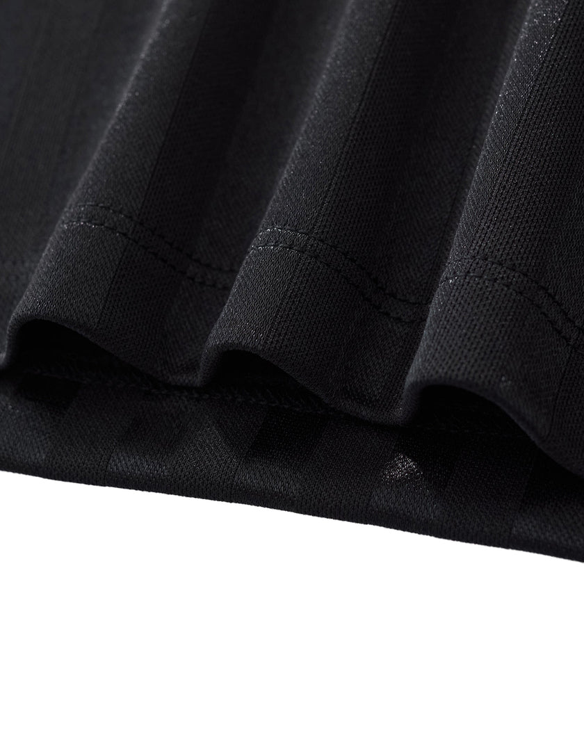 Bottom hem detail closeup of the Athlesi TrackLine Varsity Jersey in black and white