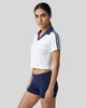Mid body front angle view of a woman wearing the Athlesi TrackLine Varsity Jersey in white and navy blue