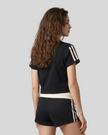 Upper body back view of the Athlesi TrackLine Varsity Tee in black