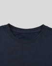 Closeup of the ribbed crew neckline on the Athlesi TrackLine Varsity Tee in blue