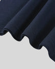 Bottom hem closeup of the Athlesi TrackLine Varsity Tee in blue