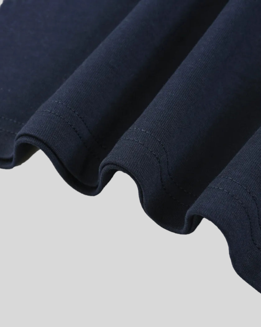 Bottom hem closeup of the Athlesi TrackLine Varsity Tee in blue