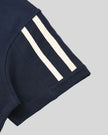 Closeup of the varsity stripe sleeve hem detail on the Athlesi TrackLine Varsity Tee in blue