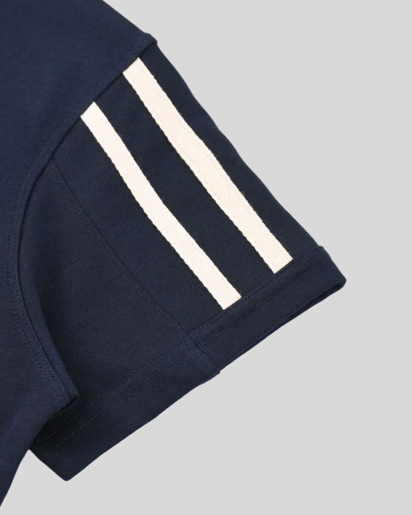 Closeup of the varsity stripe sleeve hem detail on the Athlesi TrackLine Varsity Tee in blue