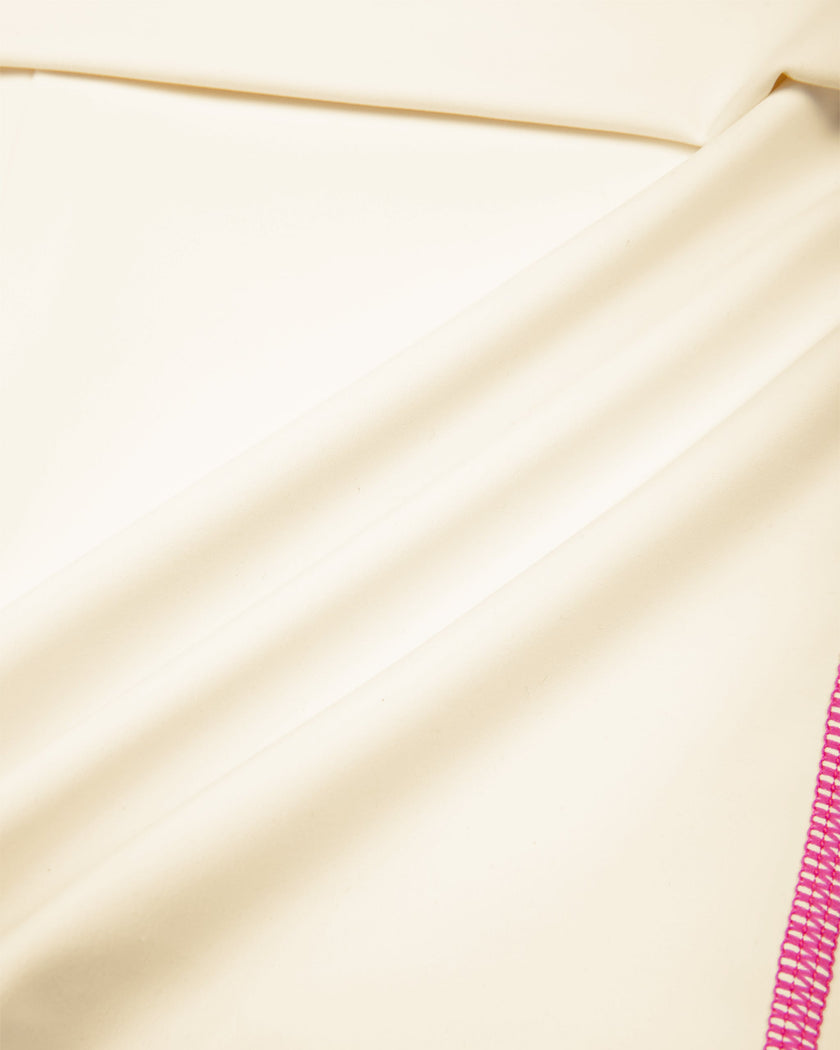 Closeup of smooth stretch fabric on TrackLine Yoga Shorts in apricot