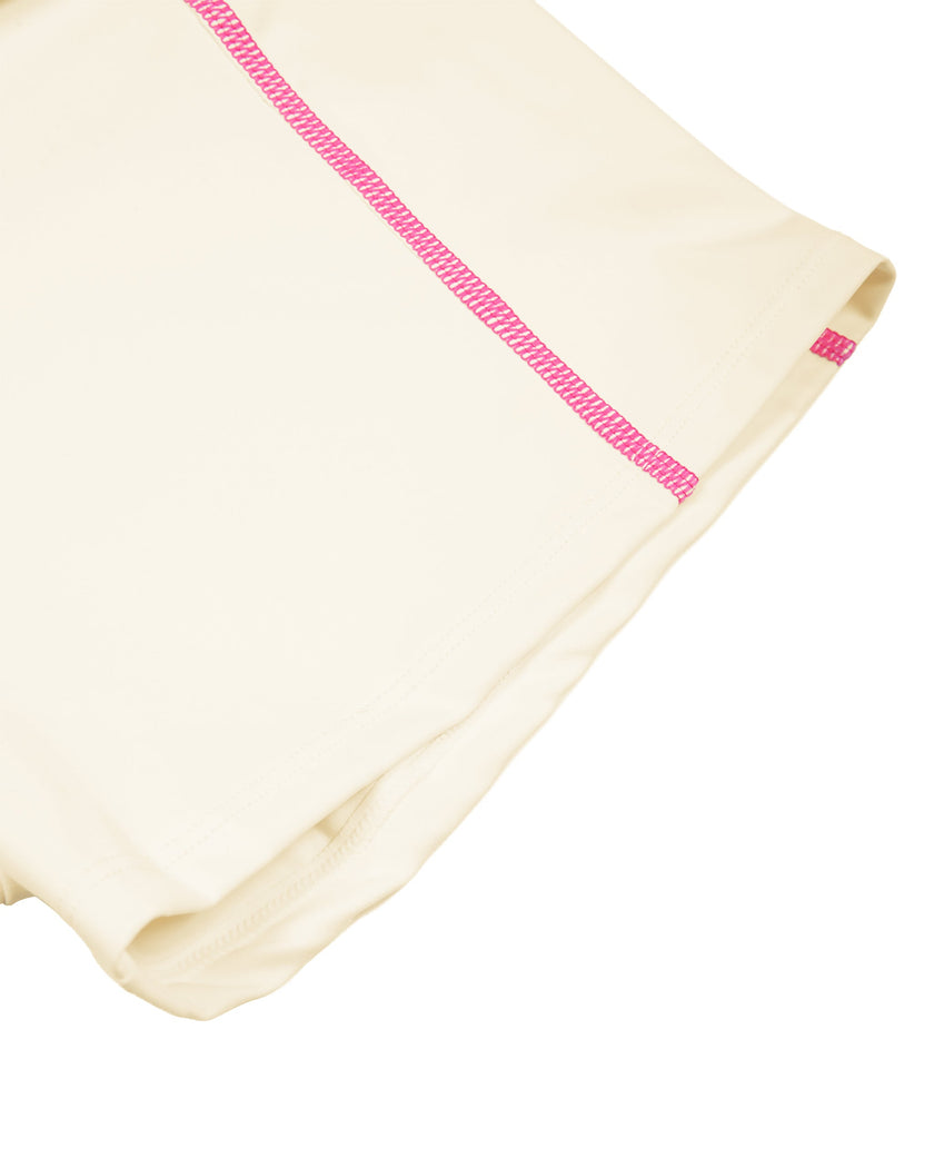 Closeup of fitted leg hem and contrast stitching on TrackLine Yoga Shorts in apricot
