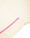 Side closeup showing contrast stitching on TrackLine Yoga Shorts in apricot