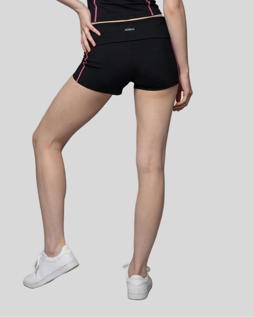 Lower body back view of woman wearing TrackLine Yoga Shorts in black
