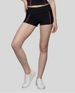 Lower body front view of woman wearing TrackLine Yoga Shorts in black