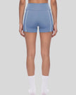 Lower body back view of woman wearing TrackLine Yoga Shorts in blue