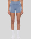 Lower body front view of woman wearing TrackLine Yoga Shorts in blue